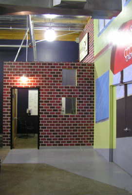 LIMELIGHT NETWORKS mural sponged brick facade of sales office as a butcher shop seamless integration of design into mural fLANSBURG dESIGN