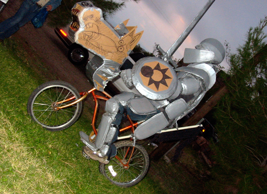 Sir Ecliptic the Liquidator Bearer of the Guantlets of Vehemence Protector of the Blade named Eleanor Cardboard Duct Tape Knights Halloween 2003 Jerome AZ Arizona Artists Create Armor and Weapons for Ole Hallows Eve Trusted Guernica Inspired Bike Steeds Tape Recorded Horse Charges Joust and Fight for the Jerome Cup fLANSBURG dESIGN