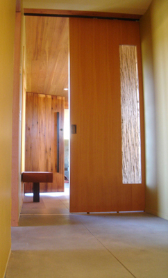 Mei Residence Reclaimed Doug Douglas Fir and Genuine Mahogany entrance huge monolithic Birchwood Casey steel 3-form and wood barn door as seen from east wing of residence Jackson Hole Wyoming fLANSBURG dESIGN in collaboration with Aric Mei